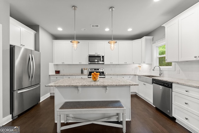 79 Brynbrooke Ct, Dawsonville, GA 30534 - kitchen with appliances with stainless steel finishes, a sink, dark wood-type flooring, white cabinets, and recessed lighting