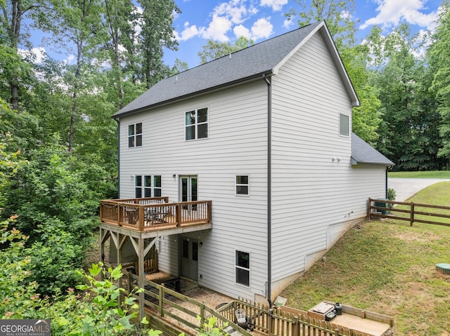79 Brynbrooke Ct, Dawsonville, GA 30534 - back of property with a wooden deck, roof with shingles, and view of wooded area