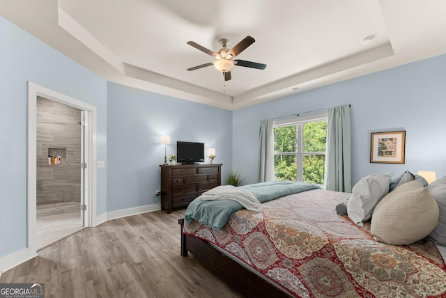 79 Brynbrooke Ct, Dawsonville, GA 30534 - bedroom with a raised ceiling, baseboards, wood finished floors, ceiling fan, and connected bathroom