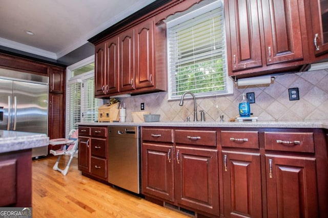 6919 Mount Zion Rd, Waco, GA 30182 - kitchen featuring stainless steel appliances, crown molding, tasteful backsplash, light wood finished floors, and a sink