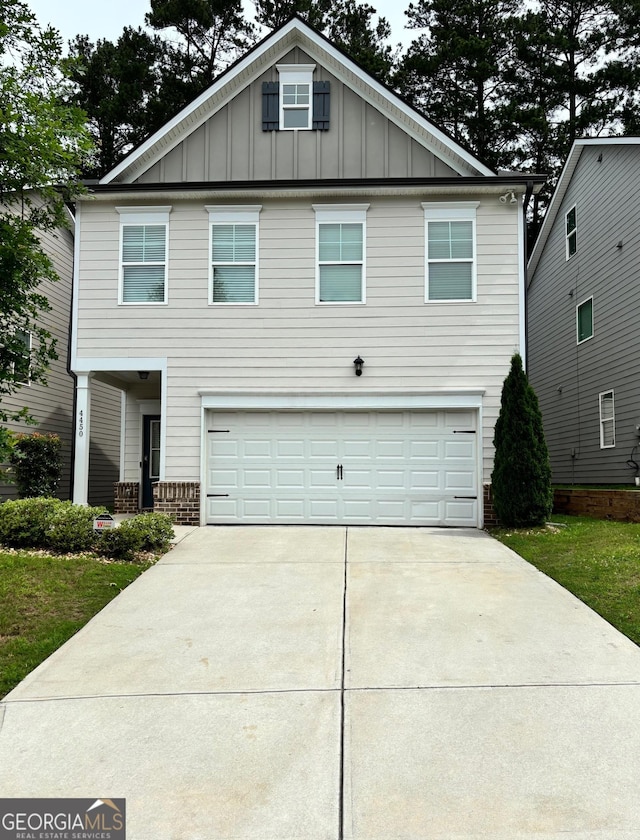 4450 Richmond Ct, Stone Mountain, GA 30083 - view of front of house with board and batten siding, an attached garage, driveway, and brick siding