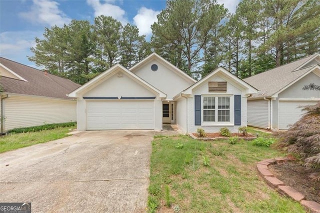 713 Fairfield Dr, Peachtree City, GA 30269 - ranch-style home with an attached garage, concrete driveway, a front yard, and stucco siding