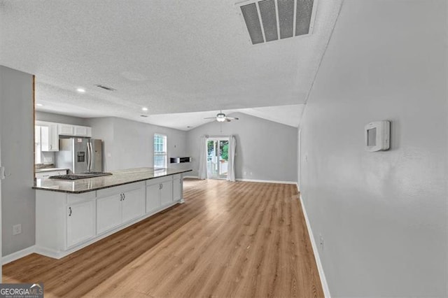 713 Fairfield Dr, Peachtree City, GA 30269 - kitchen featuring stainless steel refrigerator with ice dispenser, white cabinets, light wood finished floors, baseboards, and a textured ceiling