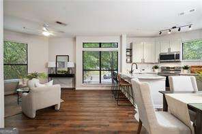 821 Ralph Mcgill Blvd NE Unit 2219, Atlanta, GA 30306 - kitchen with stainless steel microwave, dark wood-style floors, healthy amount of natural light, and light countertops