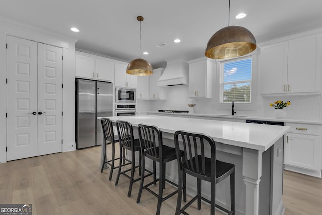 155 Lapis Lake Pt, Fayetteville, GA 30215 - kitchen featuring appliances with stainless steel finishes, custom range hood, a sink, a center island, and decorative backsplash