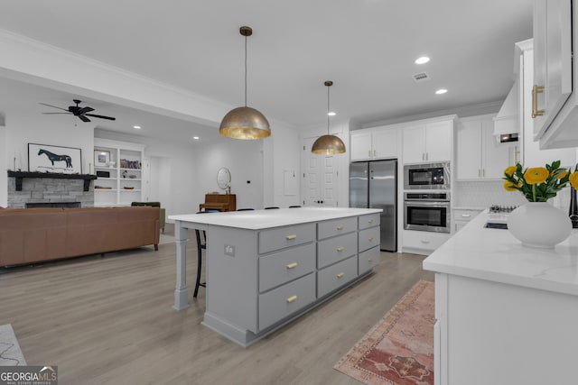 155 Lapis Lake Pt, Fayetteville, GA 30215 - kitchen featuring appliances with stainless steel finishes, gray cabinets, ornamental molding, white cabinetry, and light wood-style floors