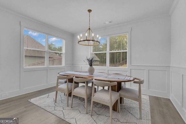 155 Lapis Lake Pt, Fayetteville, GA 30215 - dining room with a decorative wall, ornamental molding, a chandelier, wood finished floors, and a wainscoted wall