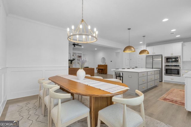 155 Lapis Lake Pt, Fayetteville, GA 30215 - dining room featuring light wood-style floors, a chandelier, ornamental molding, recessed lighting, and a wainscoted wall