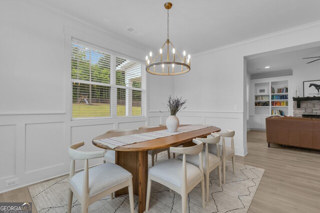 155 Lapis Lake Pt, Fayetteville, GA 30215 - dining space featuring a decorative wall, ornamental molding, a chandelier, light wood-style flooring, and a wainscoted wall