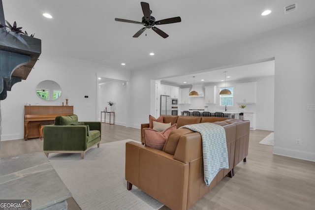 155 Lapis Lake Pt, Fayetteville, GA 30215 - living area featuring light wood-style floors, ceiling fan, recessed lighting, baseboards, and crown molding