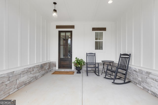 155 Lapis Lake Pt, Fayetteville, GA 30215 - property entrance featuring board and batten siding, a patio area, and stone siding