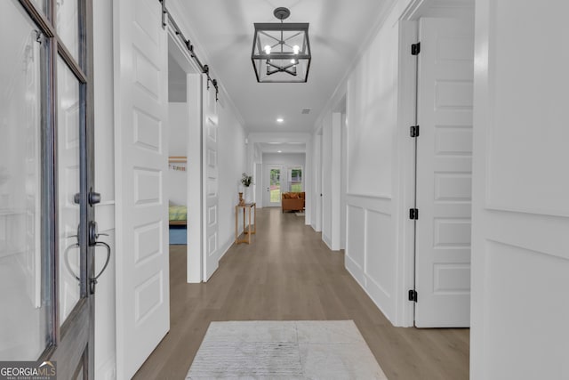 155 Lapis Lake Pt, Fayetteville, GA 30215 - corridor with a barn door, wood finished floors, crown molding, and recessed lighting