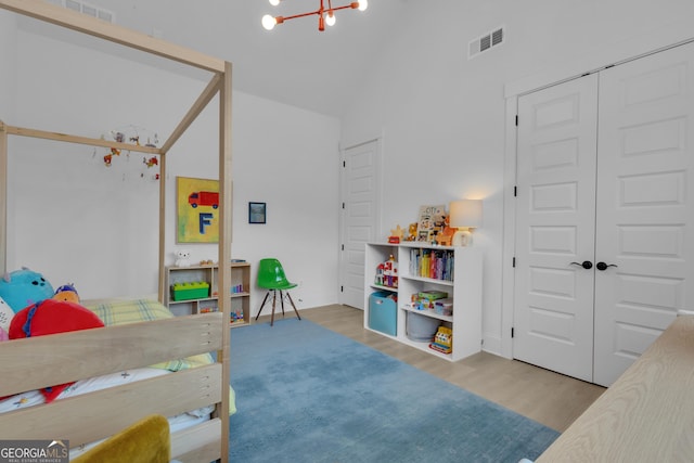 155 Lapis Lake Pt, Fayetteville, GA 30215 - bedroom with wood finished floors, vaulted ceiling, a chandelier, and a closet