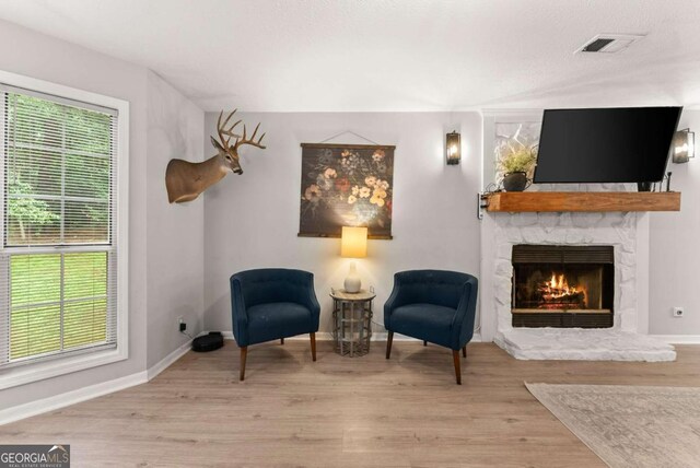 239 Hidden Ct, Winder, GA 30680 - sitting room featuring a fireplace, wood finished floors, and baseboards