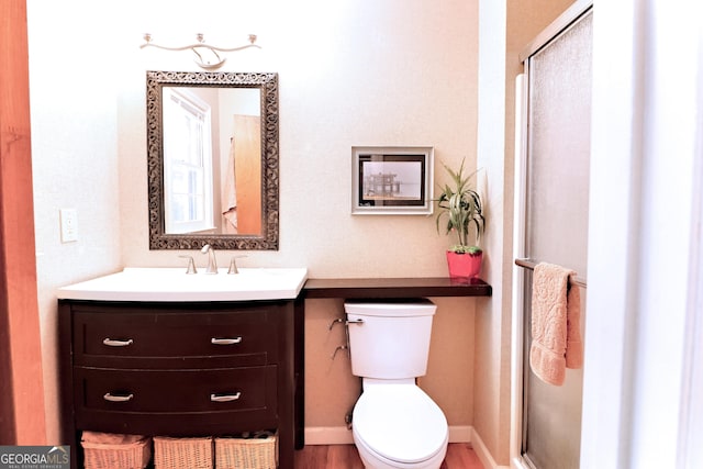 3320 Bryant Ln, Marietta, GA 30066 - bathroom featuring vanity, a shower with door, and wood finished floors