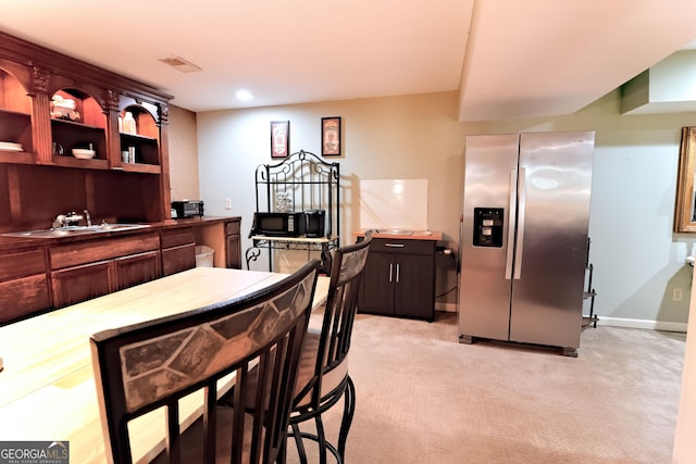 3320 Bryant Ln, Marietta, GA 30066 - kitchen featuring stainless steel refrigerator with ice dispenser, light colored carpet, and dark brown cabinets