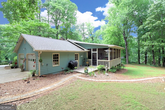 3320 Bryant Ln, Marietta, GA 30066 - view of front of home featuring a sunroom, roof with shingles, a front yard, a garage, and driveway