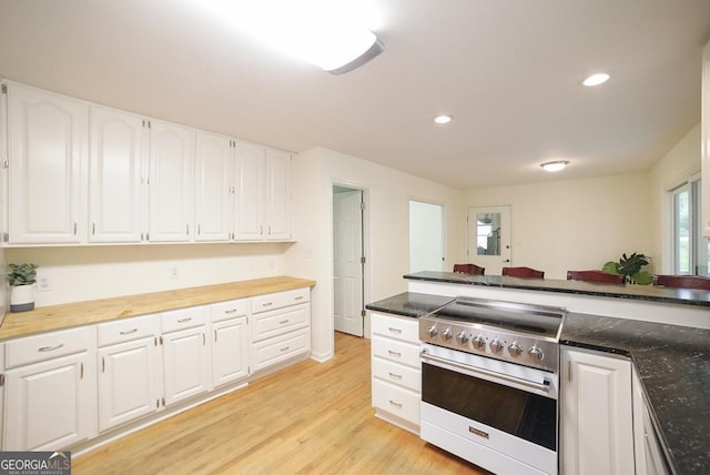 1111 Creekshore Dr, Athens, GA 30606 - kitchen with stainless steel range, light wood-style floors, white cabinetry, recessed lighting, and wooden counters