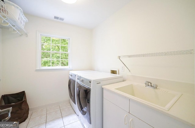1111 Creekshore Dr, Athens, GA 30606 - washroom with washing machine and dryer, cabinet space, light tile patterned floors, and baseboards