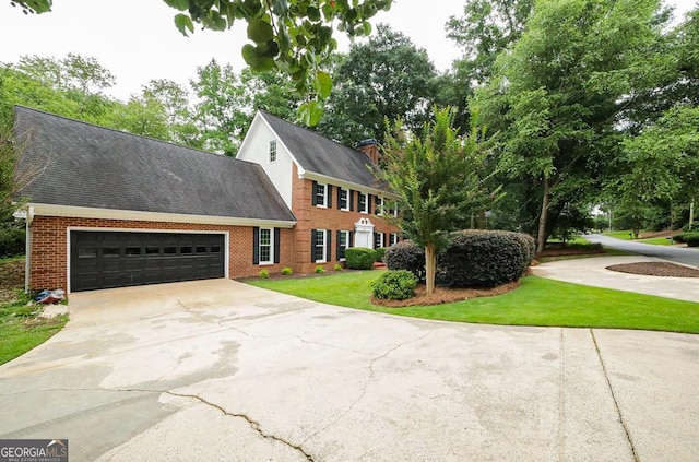 1111 Creekshore Dr, Athens, GA 30606 - colonial home featuring driveway, brick siding, an attached garage, a front lawn, and a shingled roof
