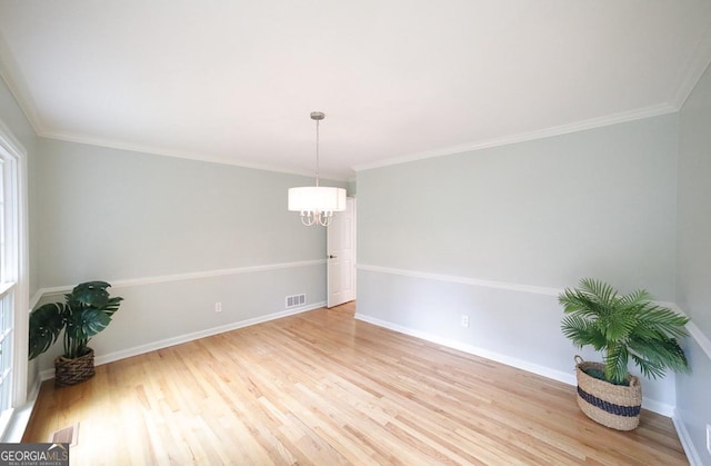1111 Creekshore Dr, Athens, GA 30606 - empty room featuring a chandelier, light wood-type flooring, baseboards, and ornamental molding