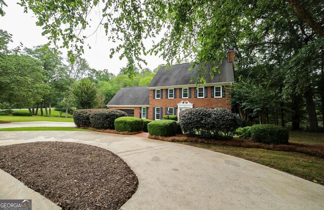 1111 Creekshore Dr, Athens, GA 30606 - view of front of property with brick siding, a chimney, and curved driveway