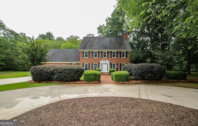 1111 Creekshore Dr, Athens, GA 30606 - colonial home with brick siding, a chimney, and curved driveway