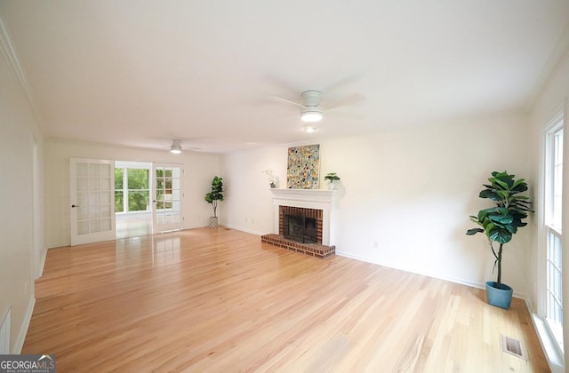 1111 Creekshore Dr, Athens, GA 30606 - unfurnished living room with a ceiling fan, light wood finished floors, ornamental molding, a fireplace, and baseboards