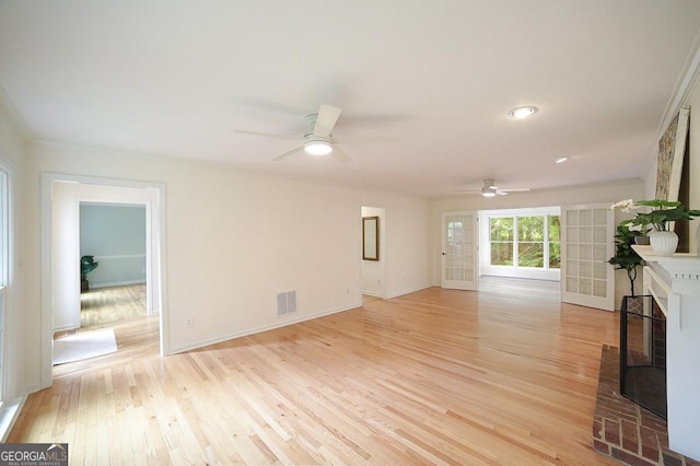 1111 Creekshore Dr, Athens, GA 30606 - unfurnished living room with a ceiling fan, light wood-style floors, a fireplace, and baseboards
