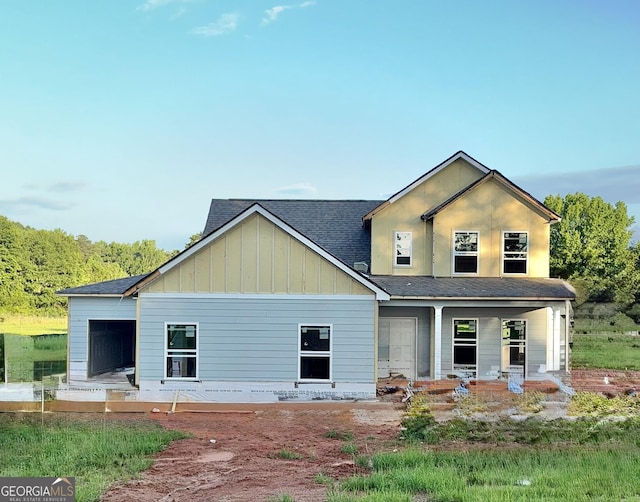 58 Maddox Dr, Mcdonough, GA 30252 - view of front facade with a shingled roof, a porch, and board and batten siding