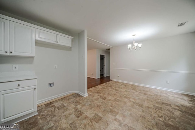 40 Heather Woods Ct, Covington, GA 30016 - unfurnished room featuring a chandelier and baseboards