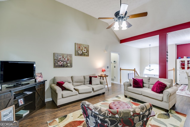 129 Onyx Ct, Carrollton, GA 30116 - living area featuring a ceiling fan, wood finished floors, high vaulted ceiling, a chandelier, and baseboards