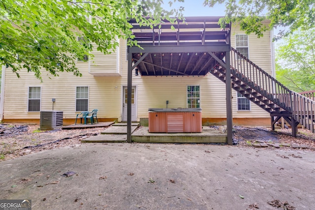 129 Onyx Ct, Carrollton, GA 30116 - back of property featuring a hot tub, a deck, central AC unit, a patio, and stairway