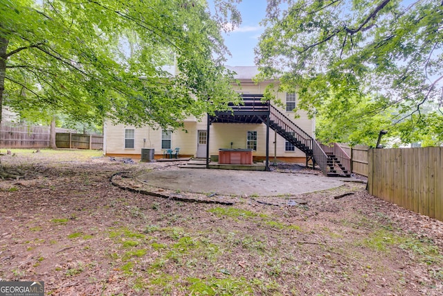 129 Onyx Ct, Carrollton, GA 30116 - rear view of property with a covered hot tub, a fenced backyard, stairs, a patio area, and central AC unit