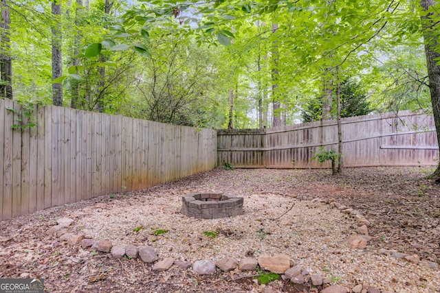 129 Onyx Ct, Carrollton, GA 30116 - fenced backyard featuring a fire pit