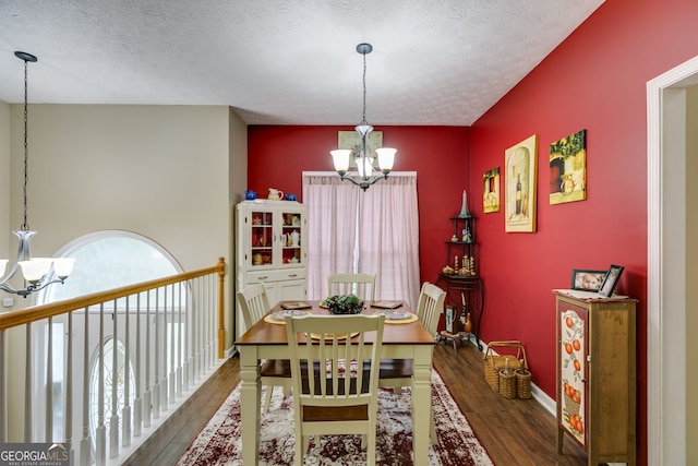 129 Onyx Ct, Carrollton, GA 30116 - dining space featuring a chandelier, wood-type flooring, a textured ceiling, and baseboards