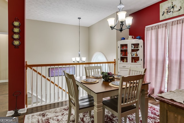 129 Onyx Ct, Carrollton, GA 30116 - dining area featuring a chandelier, wood finished floors, and a textured ceiling