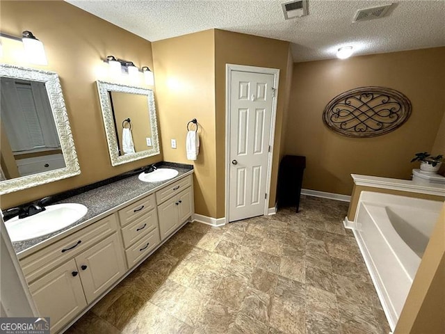 298 Moorings Run, Jasper, GA 30143 - bathroom featuring double vanity, a garden tub, a textured ceiling, and stone finish flooring