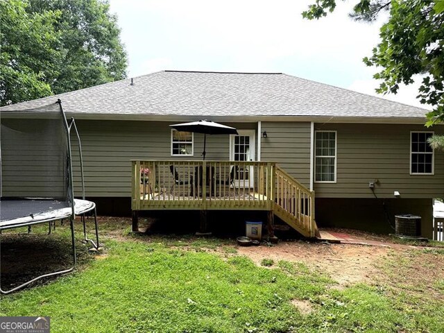 298 Moorings Run, Jasper, GA 30143 - rear view of property featuring a trampoline, a wooden deck, a lawn, and a shingled roof