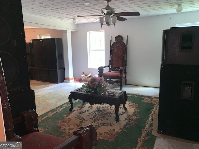 6570 Laurens Way, Stone Mountain, GA 30087 - living area with ceiling fan, ornate columns, and light tile patterned floors