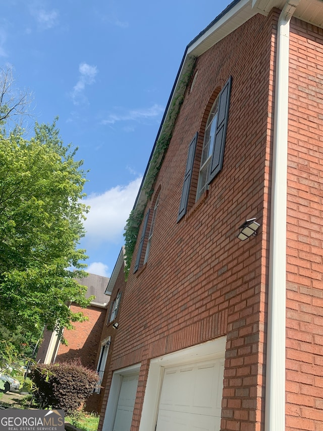 6570 Laurens Way, Stone Mountain, GA 30087 - view of side of home with brick siding and an attached garage