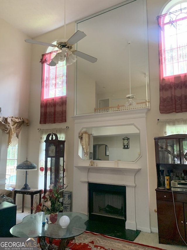 6570 Laurens Way, Stone Mountain, GA 30087 - living area featuring ceiling fan, a fireplace, and a towering ceiling