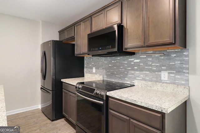 304 Boomer Ct, Guyton, GA 31312 - kitchen with electric stove, baseboards, light countertops, and backsplash