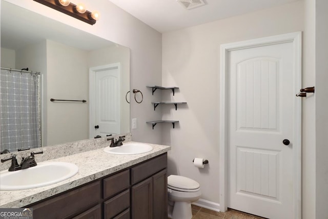 304 Boomer Ct, Guyton, GA 31312 - bathroom with double vanity, toilet, tile patterned flooring, and baseboards
