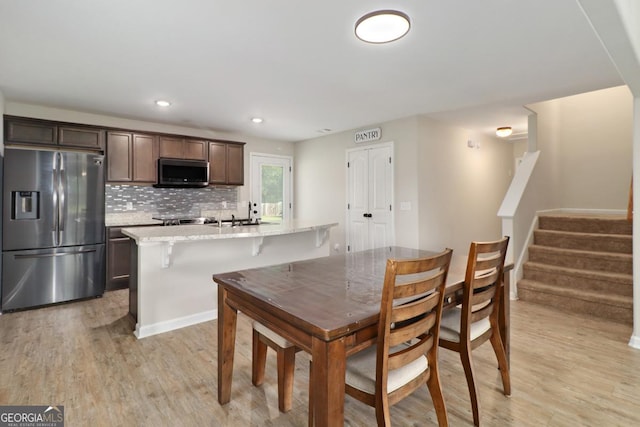 304 Boomer Ct, Guyton, GA 31312 - dining space with light wood-type flooring, stairway, and recessed lighting