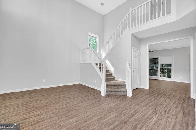 6708 Thornwood Ct, Flowery Branch, GA 30542 - foyer entrance featuring wood finished floors, stairs, baseboards, and a high ceiling
