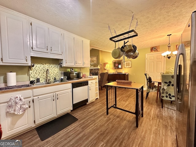 150 Willow Shoals Dr, Covington, GA 30016 - kitchen with dishwasher, freestanding refrigerator, white cabinetry, dark wood finished floors, and a textured ceiling