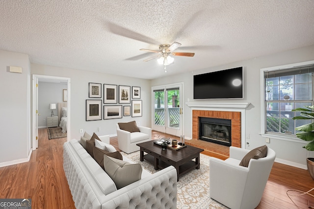 514 Mcgill Pl NE, Atlanta, GA 30312 - living area featuring ceiling fan, wood finished floors, healthy amount of natural light, and a textured ceiling