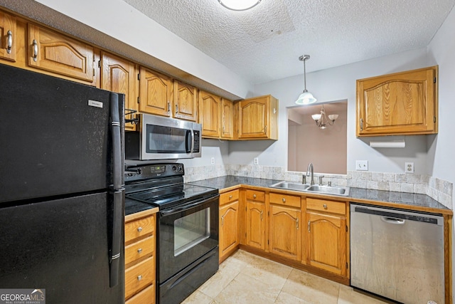 514 Mcgill Pl NE, Atlanta, GA 30312 - kitchen featuring black appliances, a sink, brown cabinets, light tile patterned floors, and a textured ceiling