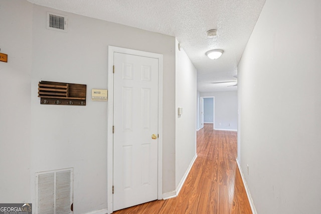 514 Mcgill Pl NE, Atlanta, GA 30312 - hallway with light wood finished floors, baseboards, and a textured ceiling